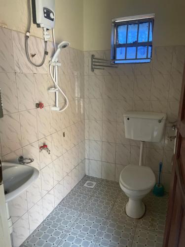 KihihiSuba Motel的浴室配有卫生间、淋浴和盥洗盆。