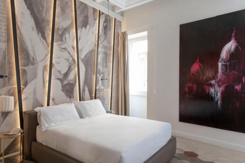 罗马BDB Rooms Navona的卧室配有白色的床和大画作
