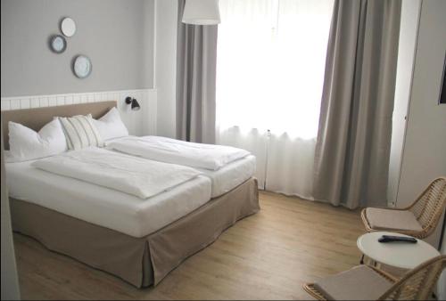诺德代希Strandhuus Norddeich的一间卧室设有一张床和一个大窗户