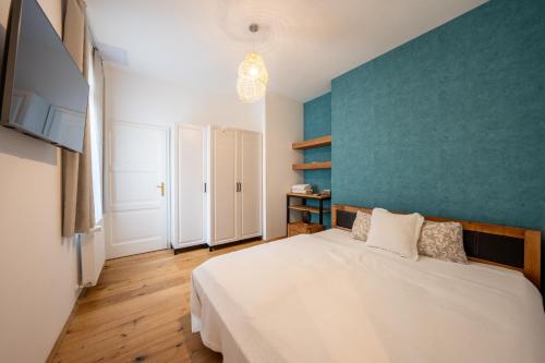 泽拜盖尼Völgy Villa的卧室配有白色的床和蓝色的墙壁