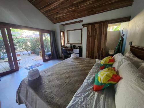 波特雷罗Villas Pura Vibra的一间卧室设有一张大床和大窗户
