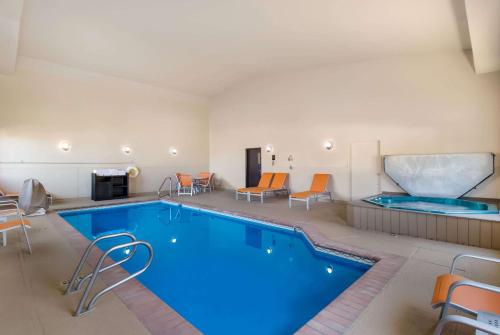 斯廷博特斯普林斯斯廷博特斯普林斯品质酒店及套房的酒店客房的大型游泳池配有椅子