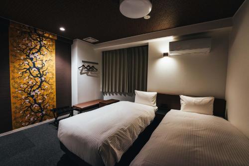 佐贺市TAPSTAY HOTEL - Vacation STAY 35230v的一间卧室设有两张床,墙上挂着一幅画