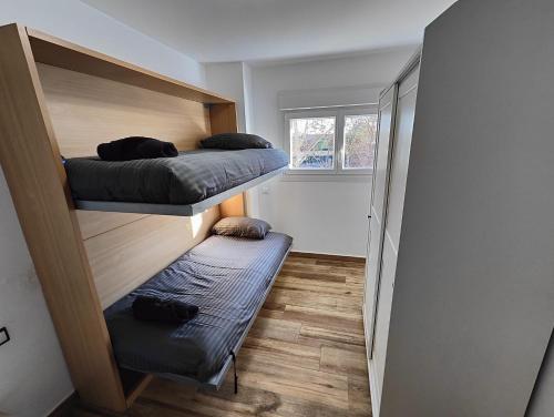 Las CortsLovely Flat Fira Barcelona的小房间设有两张双层床和窗户