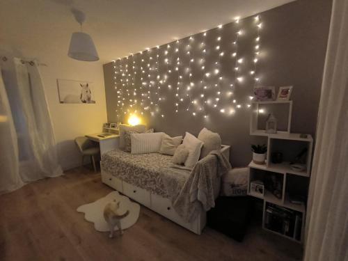 滨海拉塞讷Appartement cosy proche mer的卧室配有一张挂在墙上的灯光床。