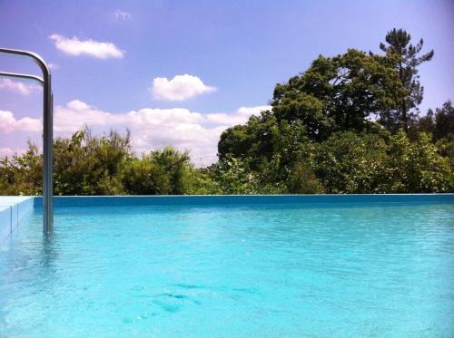 佩纳菲耶尔Eira das Carvalhas的一片蓝水,有树在后面