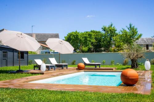 Vendeuvre-du-PoitouLes Olympiades - Magnifique Villa d'évasion的后院设有带椅子和遮阳伞的游泳池