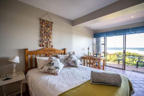阿尔弗雷德港The Spinning Reel Beach Cottages的一间卧室设有一张床,享有海景