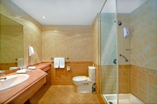 考拉亚湾Bliss Nada Beach Resort的浴室配有卫生间、盥洗盆和淋浴。