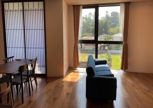 小田原市THE VIEW Odawara shiro-no mieru hotel - Vacation STAY 66140v的客厅配有蓝色的沙发和桌子