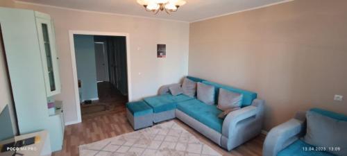 乌斯季卡缅诺戈尔斯克Lux Home на берегу Ульбы的客厅配有蓝色的沙发和两把椅子