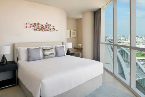 迪拜迪拜节日城洲际公寓套房酒店 的卧室设有白色的床和大窗户