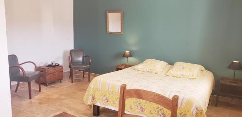 穆斯捷-圣玛丽"Les Lauriers" chambre d'hôtes indépendante avec terrasse privée的一间卧室配有一张带两把椅子和一张桌子的床。