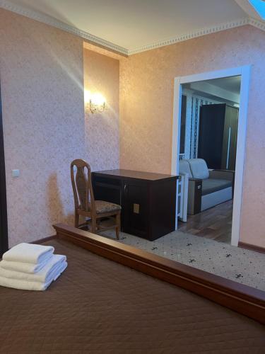 基辅拉威立雅酒店的客房设有书桌、椅子和镜子