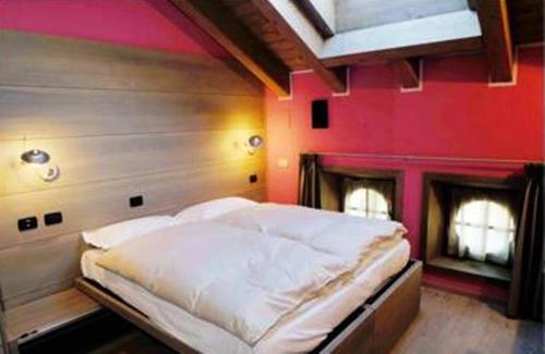 阿帕里卡塞雷内拉住宿酒店的一张大床,位于一个粉红色墙壁的房间