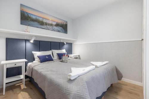 波别罗沃Pobierowo Beach Baltic Apartments by Renters的一间卧室配有一张大床和两条毛巾