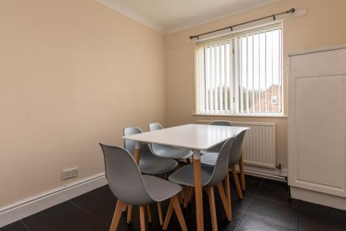 Hale3 Bed Apartment - Perfect for Contractors near Liverpool Airport的一间配备有白色桌椅的用餐室