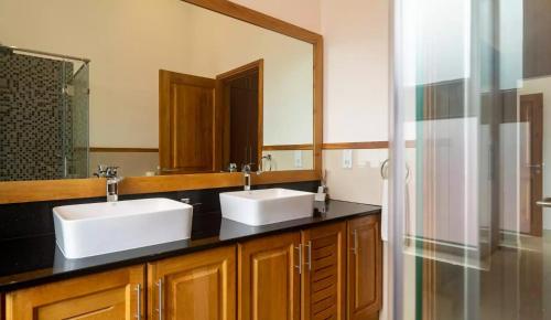 MisereCliffhanger Mountain Villas with Private Pools的一间带两个盥洗盆和大镜子的浴室
