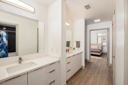 夏洛特Uptown's Elite- 4BR Luxury Oasis的白色的浴室设有两个盥洗盆和镜子