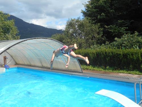 Katsch an der MurUmundumhütte的跳跳跳跳跳跳水板到游泳池的人