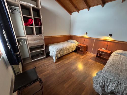 乌斯怀亚特拉因科尼塔酒店的客房铺有木地板,配有两张床。
