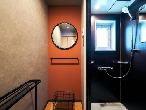 福冈Rakuten STAY Hakata Gion 302 - Rakuten Ichiba Collaboration Room -的浴室设有橙色墙壁和镜子