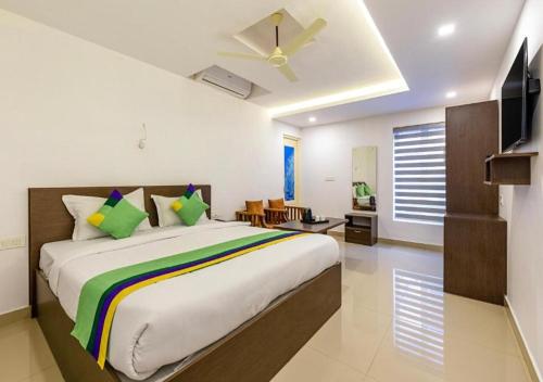 尼杜巴塞莱Airport Avenue Plaza Cochin Airport的一间卧室配有一张大床和吊扇