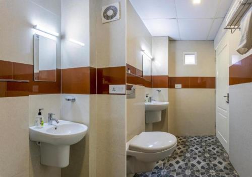 尼杜巴塞莱Airport Avenue Plaza Cochin Airport的浴室设有2个水槽、卫生间和镜子。