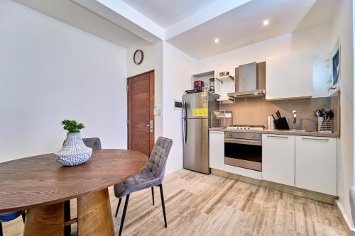 蓬塔卡纳Cana Brava Residences-Comfort Condo的一间带木桌的厨房和一间餐厅