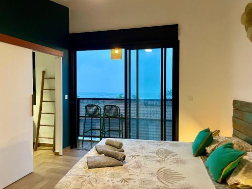 厄唐萨雷Aloes - Villa Salba. Panoramic view.的一间卧室设有一张床,享有海景