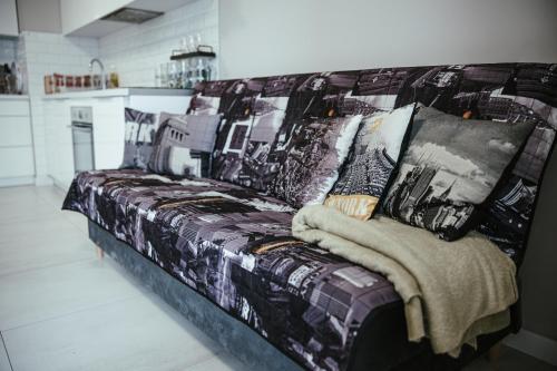 华沙Apartamenty Bokserska的厨房里一张带毯子的沙发