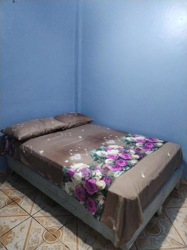 科马亚瓜Hotel 24 /7的一张床上的鲜花盛开的睡床