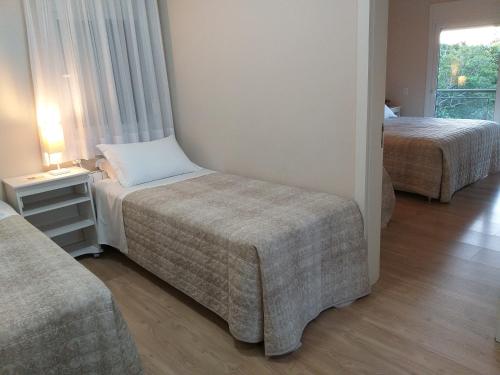 新彼得罗波利斯Casa Colina do Sol的酒店客房,设有两张床和一张沙发