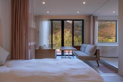 R;MOGAMI - Vacation STAY 25467v的一间卧室配有一张床、一张沙发和一张桌子
