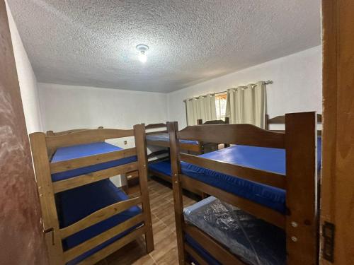 瓜鲁柳斯Rancho NPI的一间房间,设有三张双层床