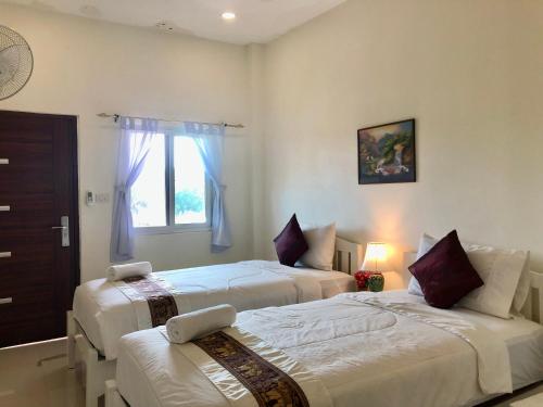 讪巴东Naraya Homestay的一间卧室设有两张床和窗户。