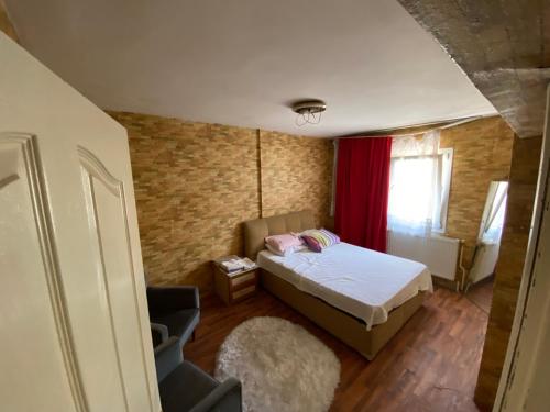 KarataşKuzey’s home的一间小卧室,配有床和红色窗帘
