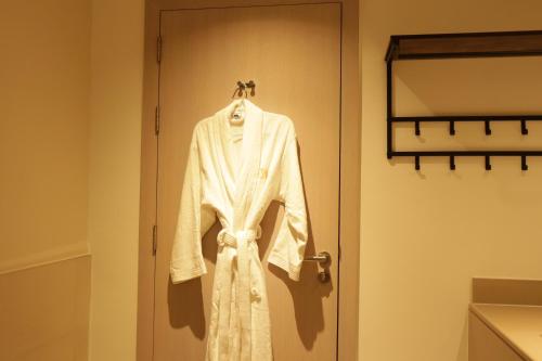 阿布扎比Twilight 1BR apartment Yas Island的挂在门上的白色长袍