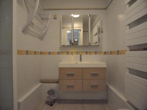 勒图凯-巴黎普拉日Victory25的一间带水槽、浴缸和镜子的浴室