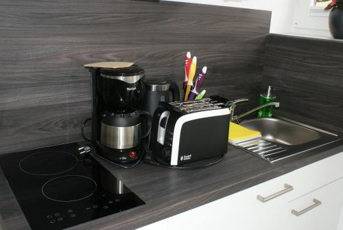 于斯德Strandhaus Rose Apartement 14的厨房柜台配有咖啡机和烤面包机