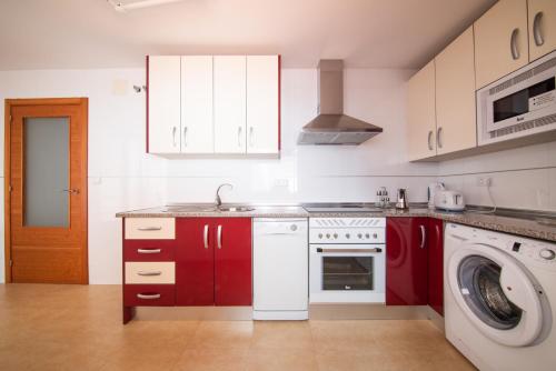圣玛丽亚港Apartamentos Moon Dreams Puerto的一间带红色橱柜和洗衣机的厨房