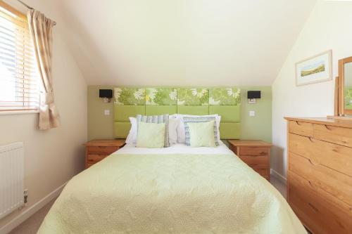 大圣科勒姆KingFisher Hot Tub & log Burner house on Premium lakeside with Resort Facilities的一间卧室设有一张床和一个窗口