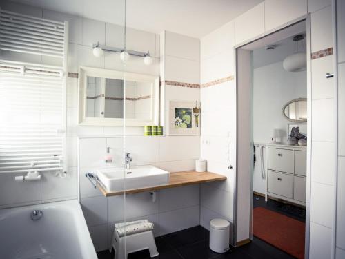 博登湖畔克雷斯波洛Ferienwohnung Seeufer的白色的浴室设有水槽和卫生间。