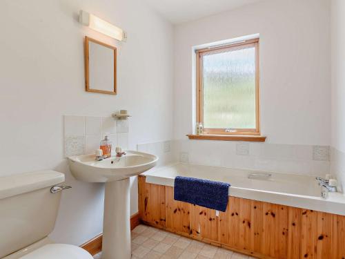 拉根3 Bed in The Cairngorms IN515的一间带水槽、浴缸和卫生间的浴室