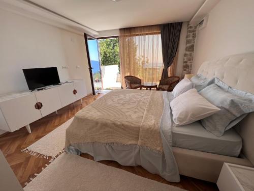 赫尔采格诺维Vila Bella Vista的一间卧室配有一张大床和电视
