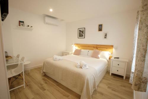 科尔多瓦La Trinidad Córdoba的卧室配有白色床和毛巾