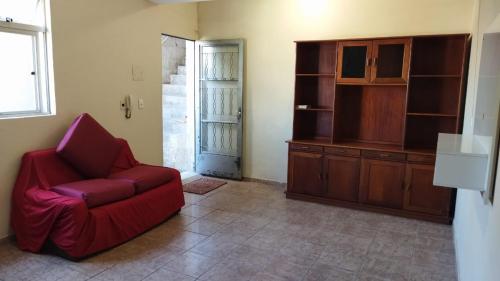 贝洛奥里藏特Hospedagem do Marcão的客厅配有红色椅子和橱柜