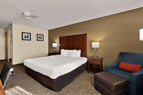 三河城三河城红杉国王峡谷康福特茵套房及酒店的酒店客房,配有一张床和一张蓝色椅子