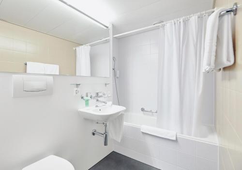 莱茵费尔登斯池艾瑞酒店的白色的浴室设有水槽和淋浴。