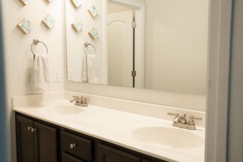 CarthageSleeps 9- In Whispering Pines的一间带两个盥洗盆和大镜子的浴室
